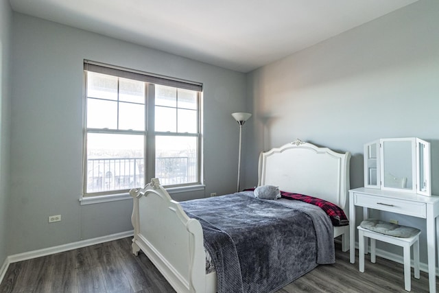 bedroom featuring multiple windows and dark hardwood / wood-style floors