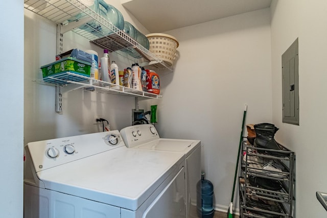 clothes washing area with electric panel and washer and dryer