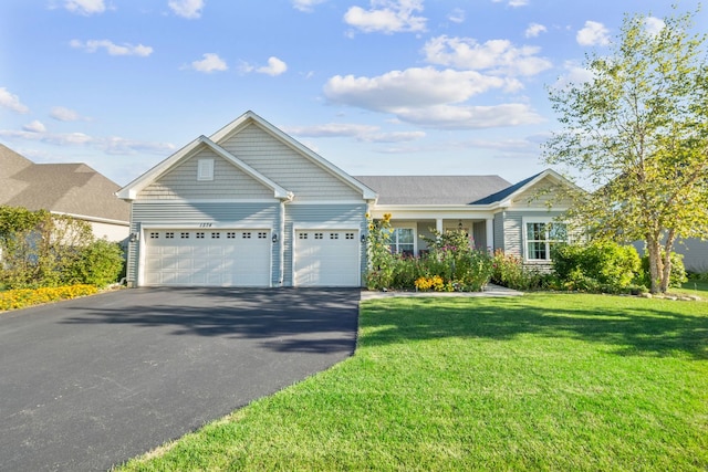 view of front of house with driveway, a garage, and a front yard