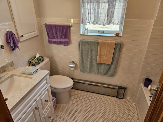 bathroom featuring tile walls, a baseboard radiator, vanity, and toilet