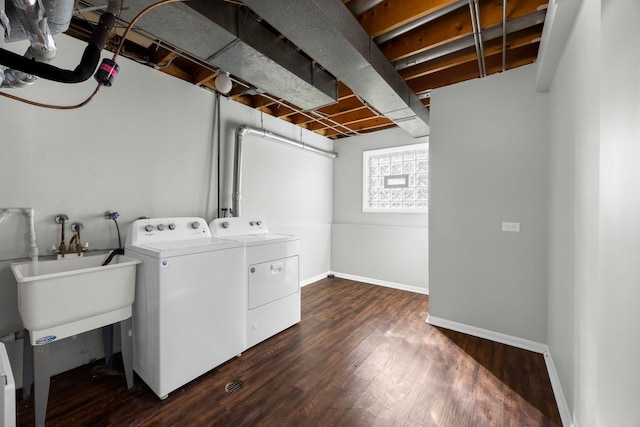 washroom with washer and clothes dryer, dark hardwood / wood-style floors, and sink