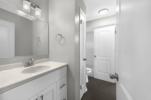 bathroom with tile patterned flooring, vanity, and toilet