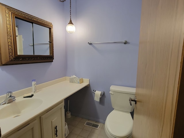 bathroom with vanity, toilet, and tile patterned floors