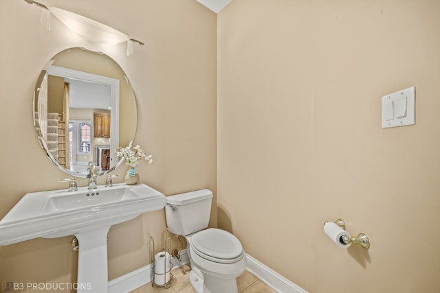 bathroom featuring toilet and tile patterned floors