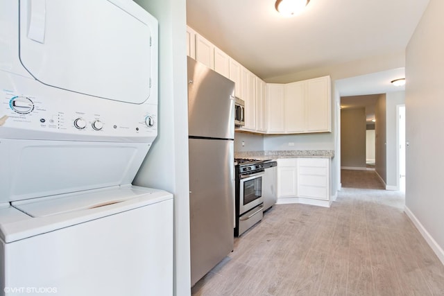 3544 W Douglas Blvd, Chicago, IL 60623 - washroom with stacked washer / drying machine and light wood-style floors