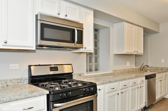 3544 W Douglas Blvd, Chicago, IL 60623 - kitchen with stainless steel appliances, white cabinets, and light stone countertops