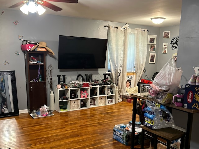 living room with wood-type flooring and ceiling fan