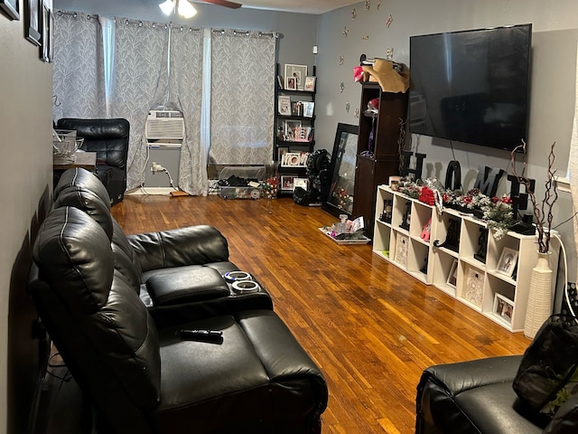 living room featuring ceiling fan and hardwood / wood-style flooring