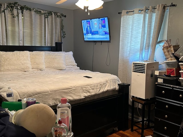 bedroom with wood-type flooring and ceiling fan