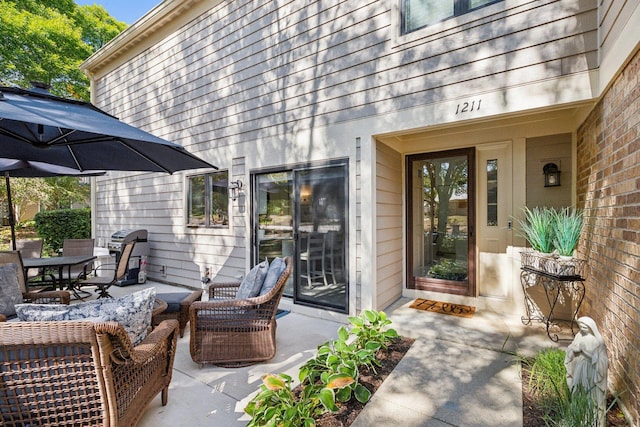 view of exterior entry with an outdoor hangout area and a patio