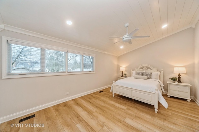 bedroom with multiple windows, ceiling fan, light hardwood / wood-style flooring, and vaulted ceiling