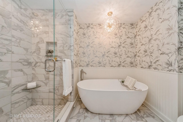 bathroom featuring separate shower and tub and an inviting chandelier