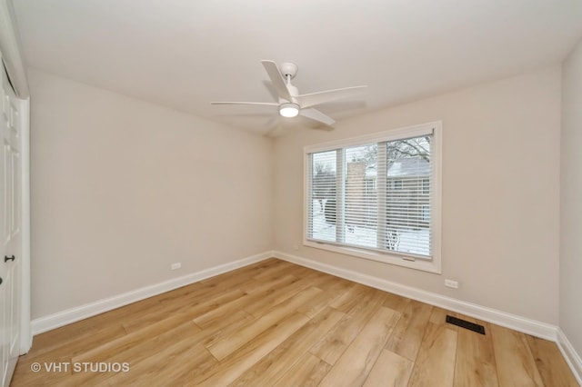 empty room featuring ceiling fan and light hardwood / wood-style flooring