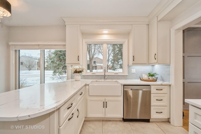 kitchen with dishwasher, backsplash, plenty of natural light, and sink