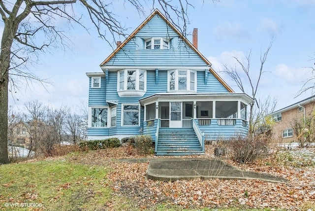 view of front of home with a sunroom