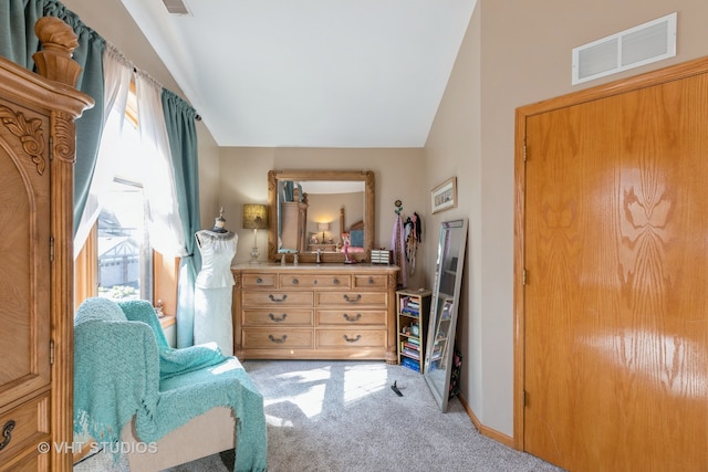 sitting room with lofted ceiling and light carpet