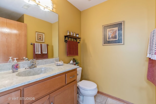 bathroom with vanity, toilet, and tile patterned floors