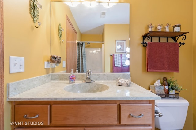 bathroom featuring vanity, toilet, and a shower with shower curtain