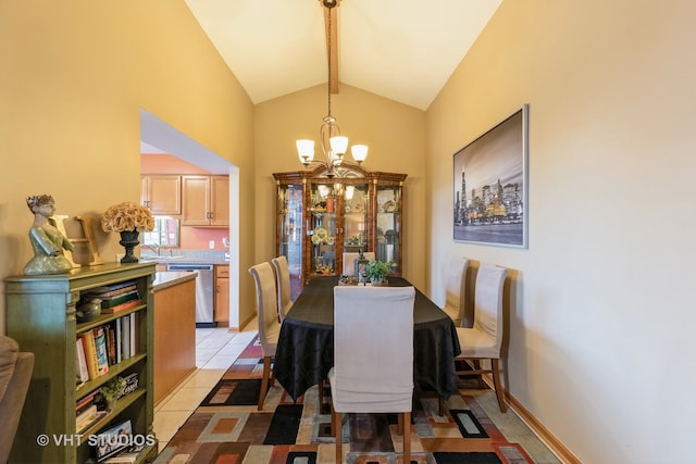 tiled dining room with an inviting chandelier, beam ceiling, sink, and high vaulted ceiling