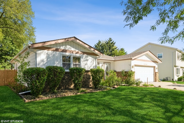 view of front of house with a garage and a front lawn