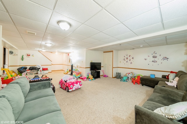 living room with carpet and a paneled ceiling