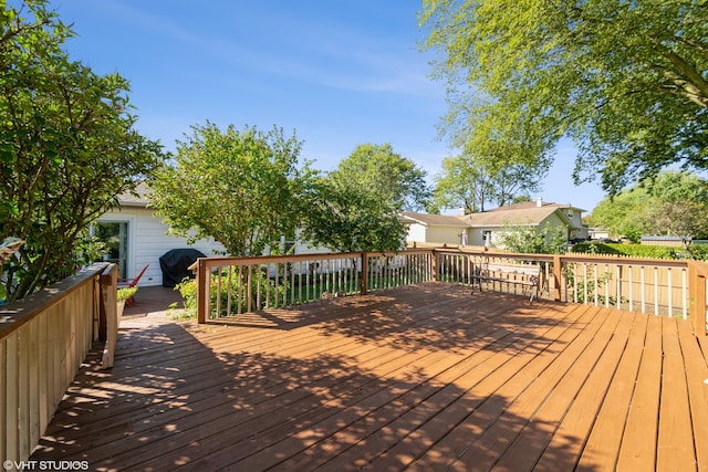 wooden deck featuring a grill