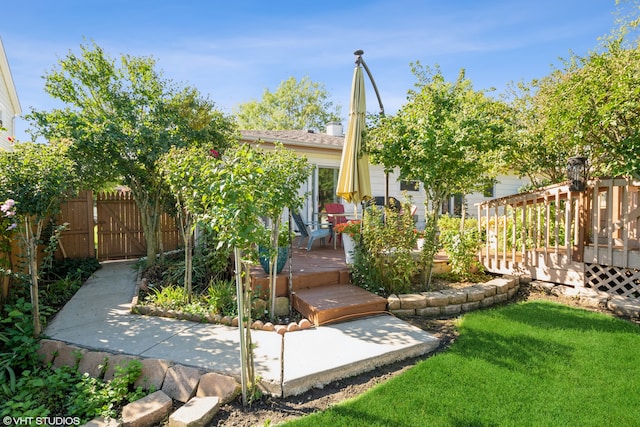 view of front facade with a front yard and a deck