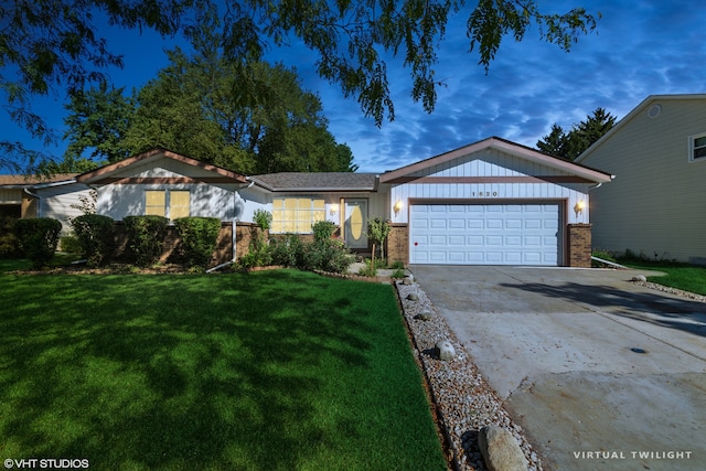 view of front of house with a front yard and a garage