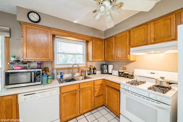 kitchen with ceiling fan, light tile patterned floors, sink, white appliances, and a textured ceiling