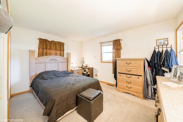 bedroom with light colored carpet