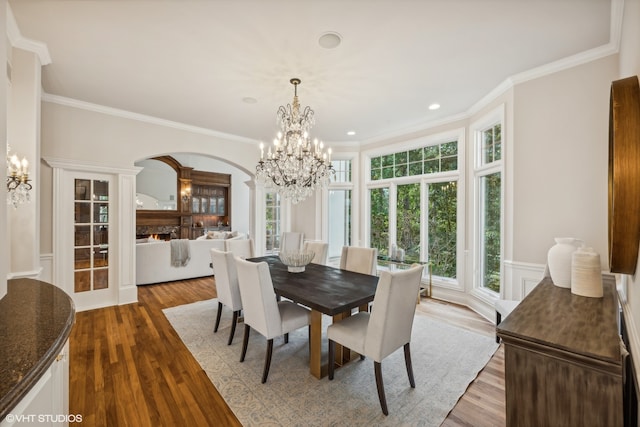 dining room featuring crown molding, a chandelier, and wood-type flooring