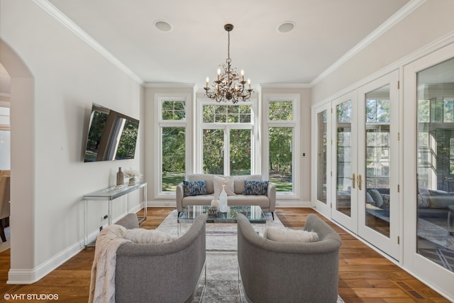 sunroom / solarium featuring a notable chandelier and a healthy amount of sunlight