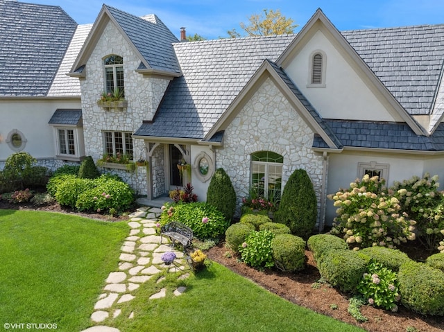 french country home with a front lawn