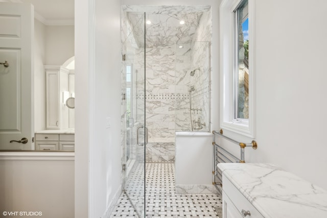 bathroom with vanity, an enclosed shower, and ornamental molding