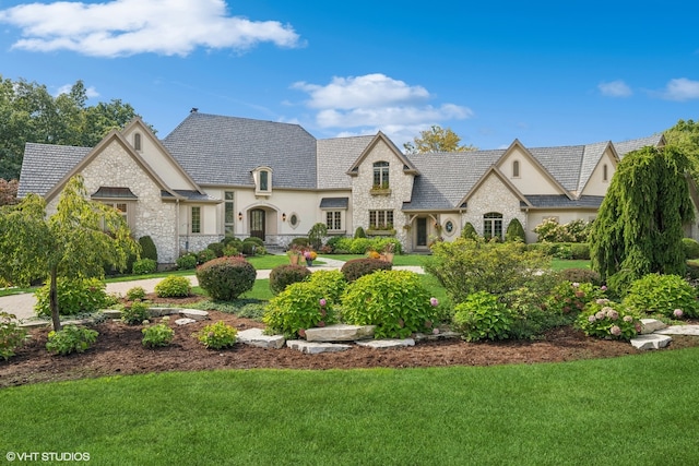 french country inspired facade with a front lawn