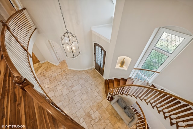 foyer entrance with a high ceiling and a chandelier