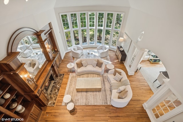 interior space featuring a towering ceiling and hardwood / wood-style flooring