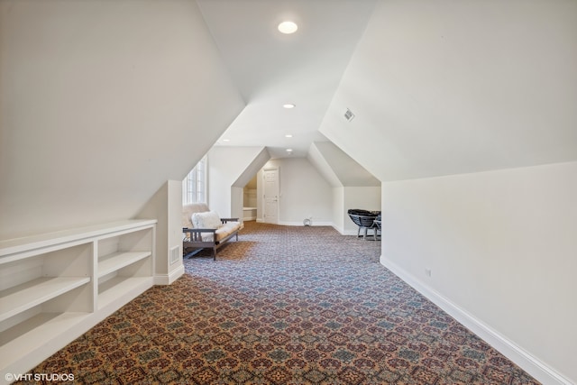 bonus room featuring carpet floors and vaulted ceiling