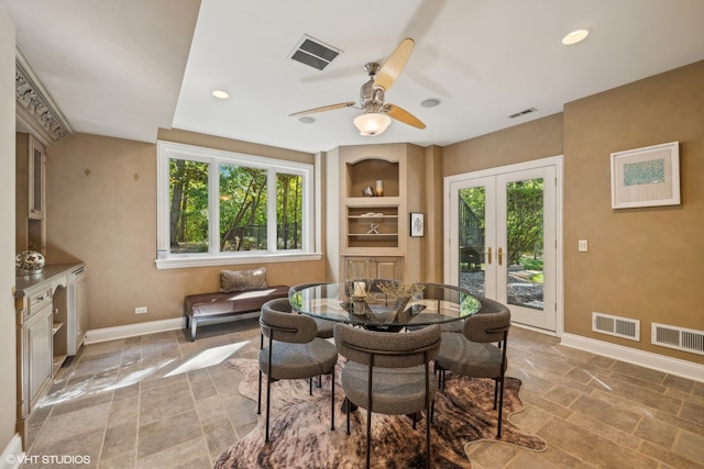 dining space featuring french doors, built in shelves, and ceiling fan