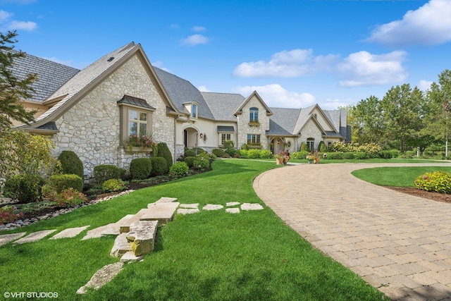 french country home featuring a front yard