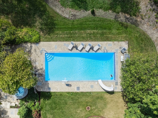 view of pool with a lawn