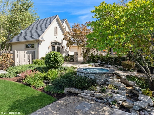 view of yard with an outdoor hot tub