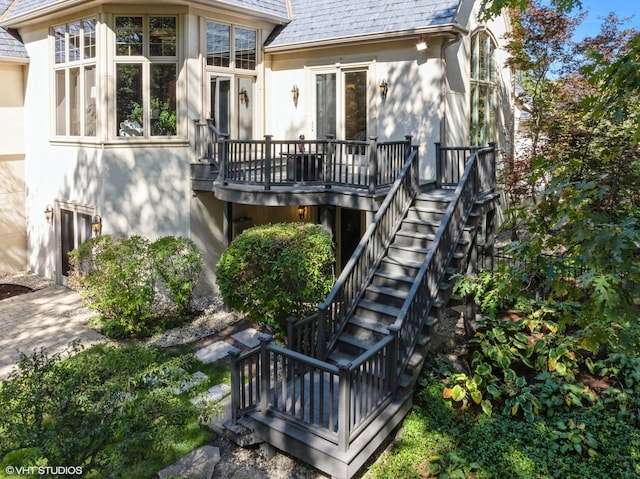 rear view of property featuring a wooden deck