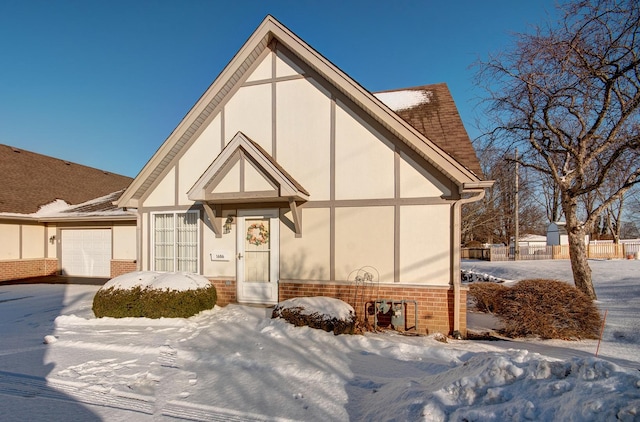 english style home with a garage