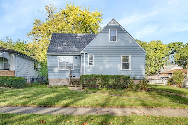18018 Wentworth Ave, Lansing, IL 60438 - view of front of house featuring fence, a shingled roof, and a front yard