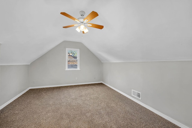 additional living space featuring carpet, vaulted ceiling, and ceiling fan