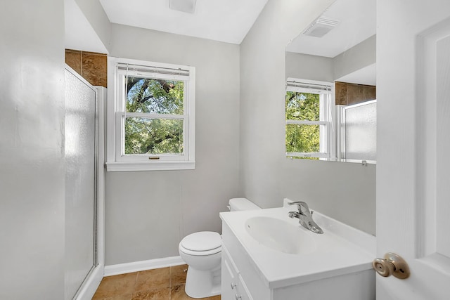 bathroom with walk in shower, vanity, and plenty of natural light