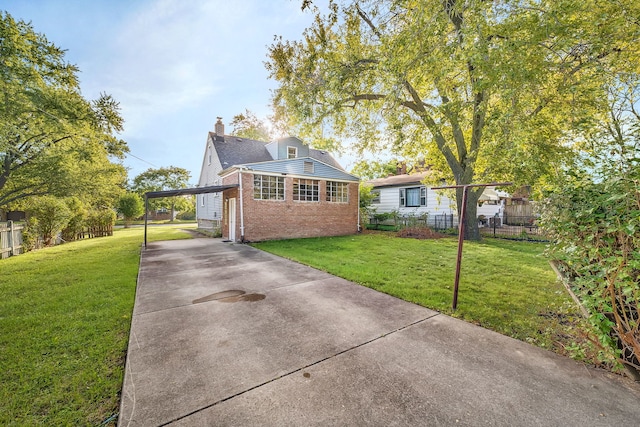 view of front facade with a front yard and a carport