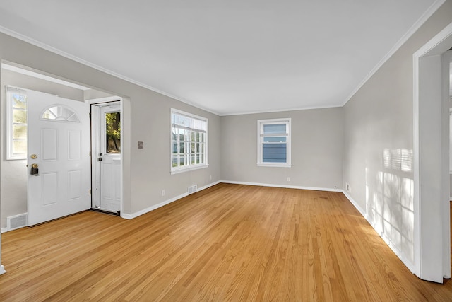 foyer with ornamental molding, light hardwood / wood-style flooring, and plenty of natural light