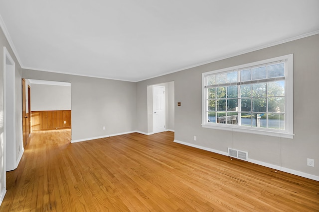 unfurnished living room with light hardwood / wood-style flooring and crown molding